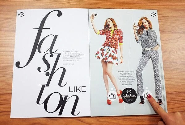Interactive print ad by C&A fashion featuring printed social media Like buttons.