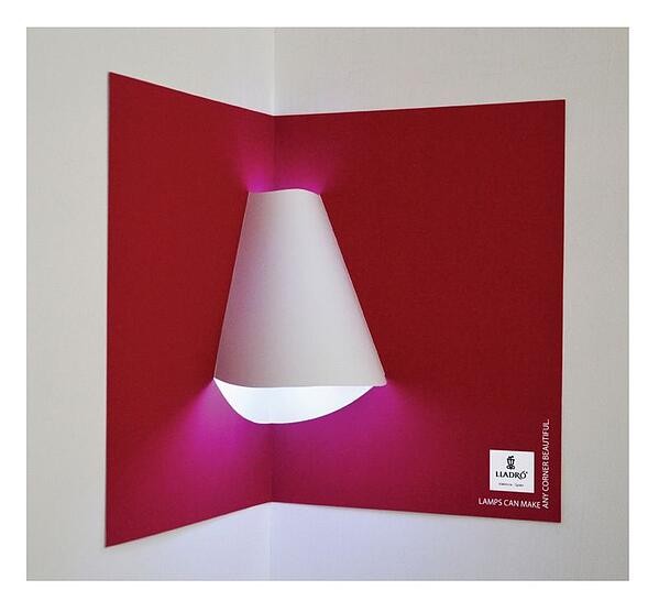 Interactive print ad by Lladro Lighting with lamp shade included in pop-up book.