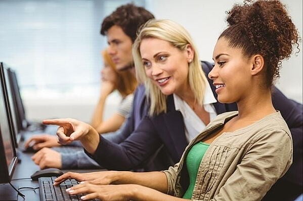 marketing professor showing college student SEO on her computer screen