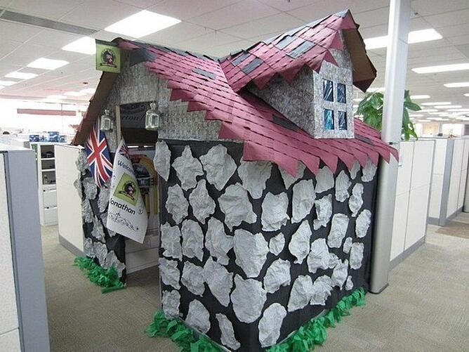 paper mache house covering coworkers cubicle