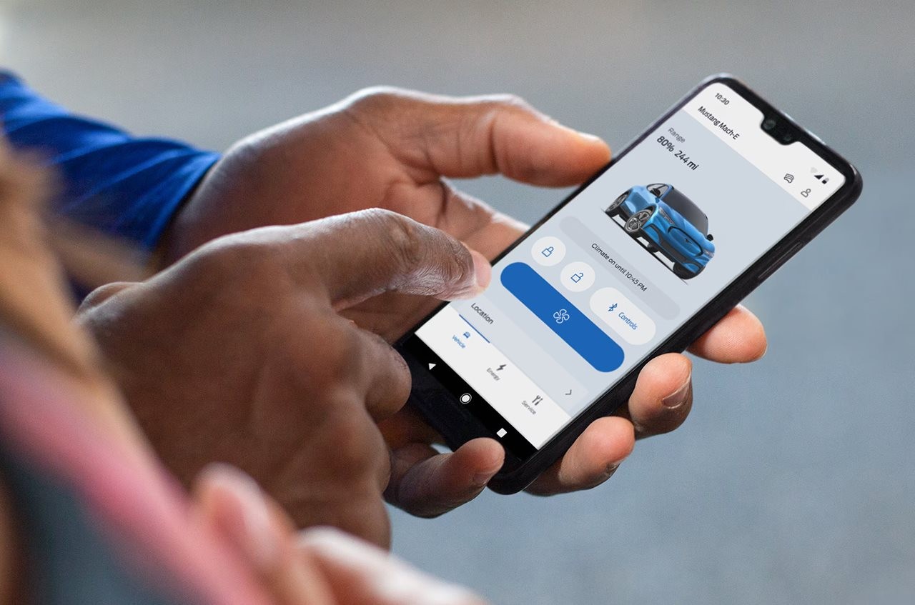 Man setting some controls for is car using his phone.